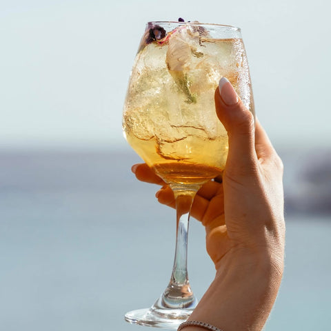 Guest relaxing at Bora Bora Beach Club with tropical drink